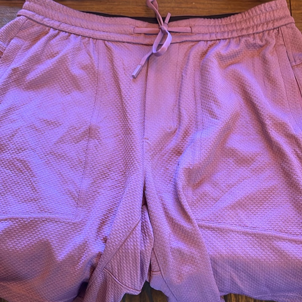 Men’s Lululemon casual athletic shorts. The color is mauve to purple. Size M